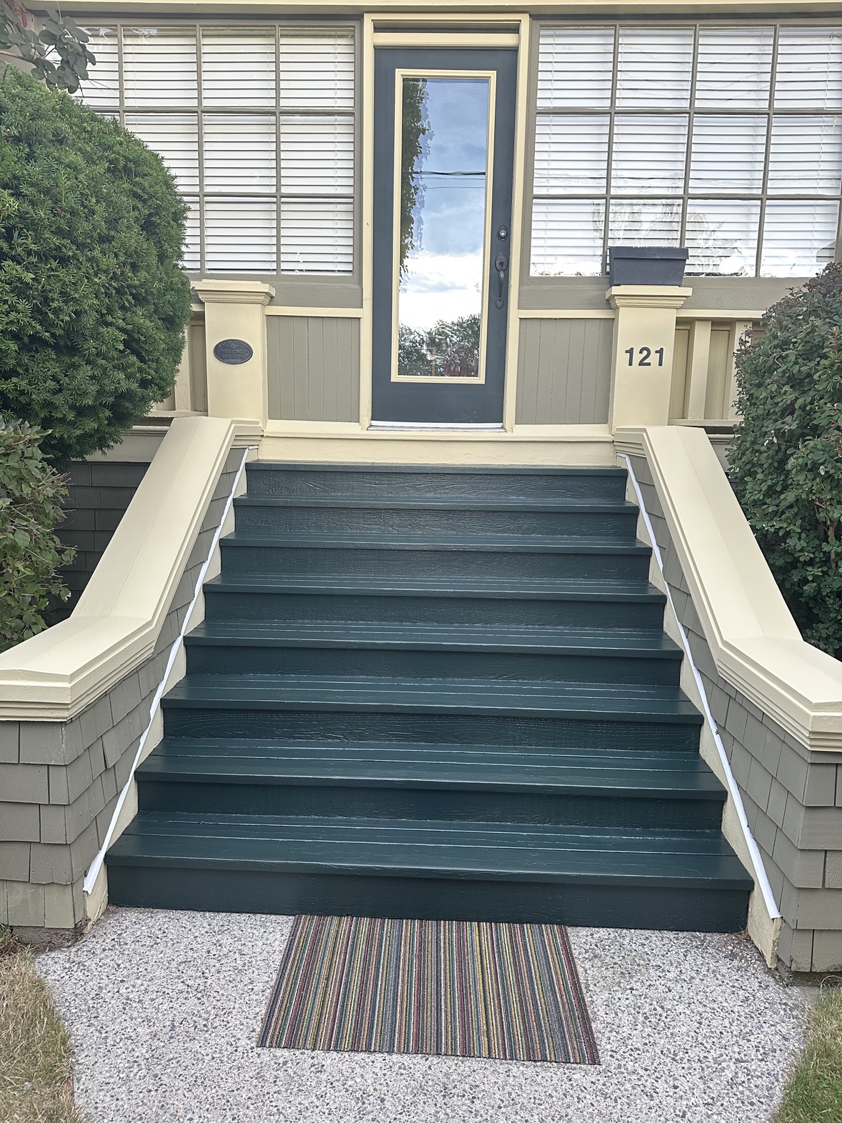 Front steps painted in deep green with cream railings in Victoria, BC