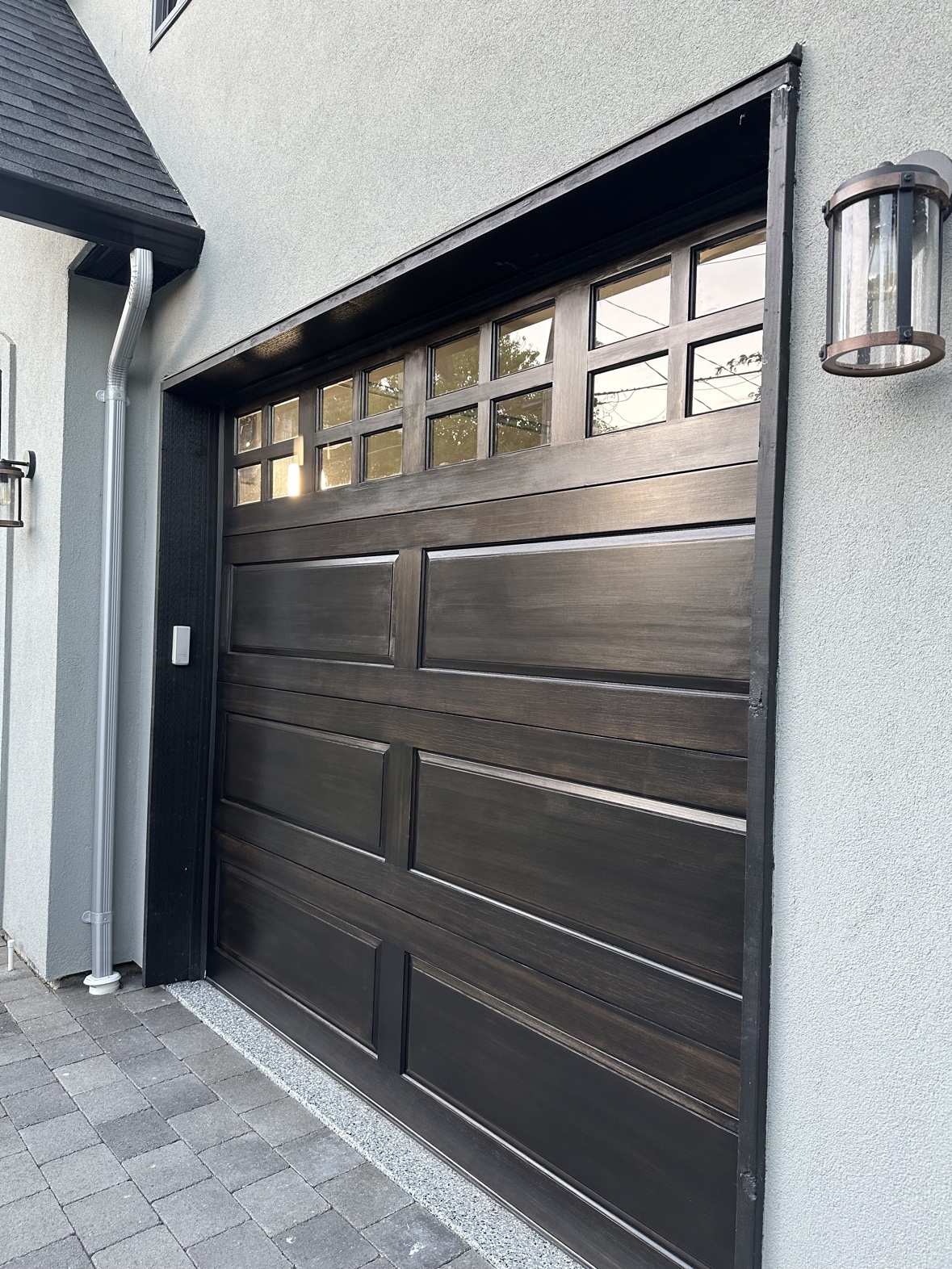 Garage door staining in a dark wood finish in Victoria, BC