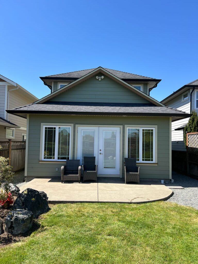 Green house exterior painting white trim victoria by Rebirth Painting Ltd. in Victoria, BC