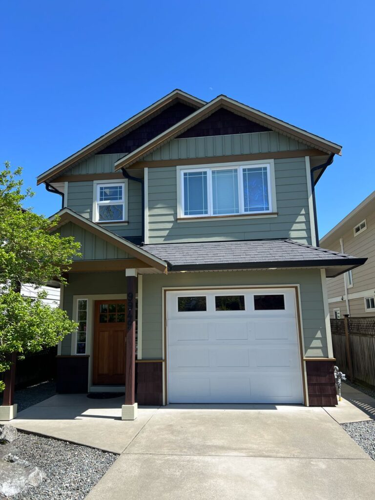 Green house painting white garage door victoria by Rebirth Painting Ltd. in Victoria, BC