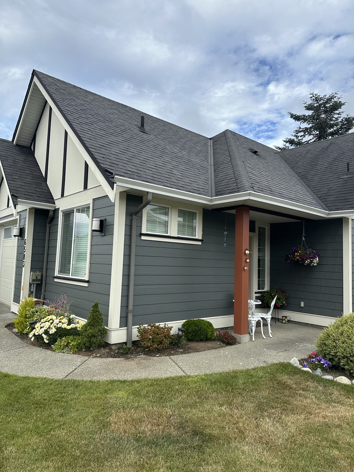 Exterior house painting with a covered porch and terracotta post in Victoria, BC