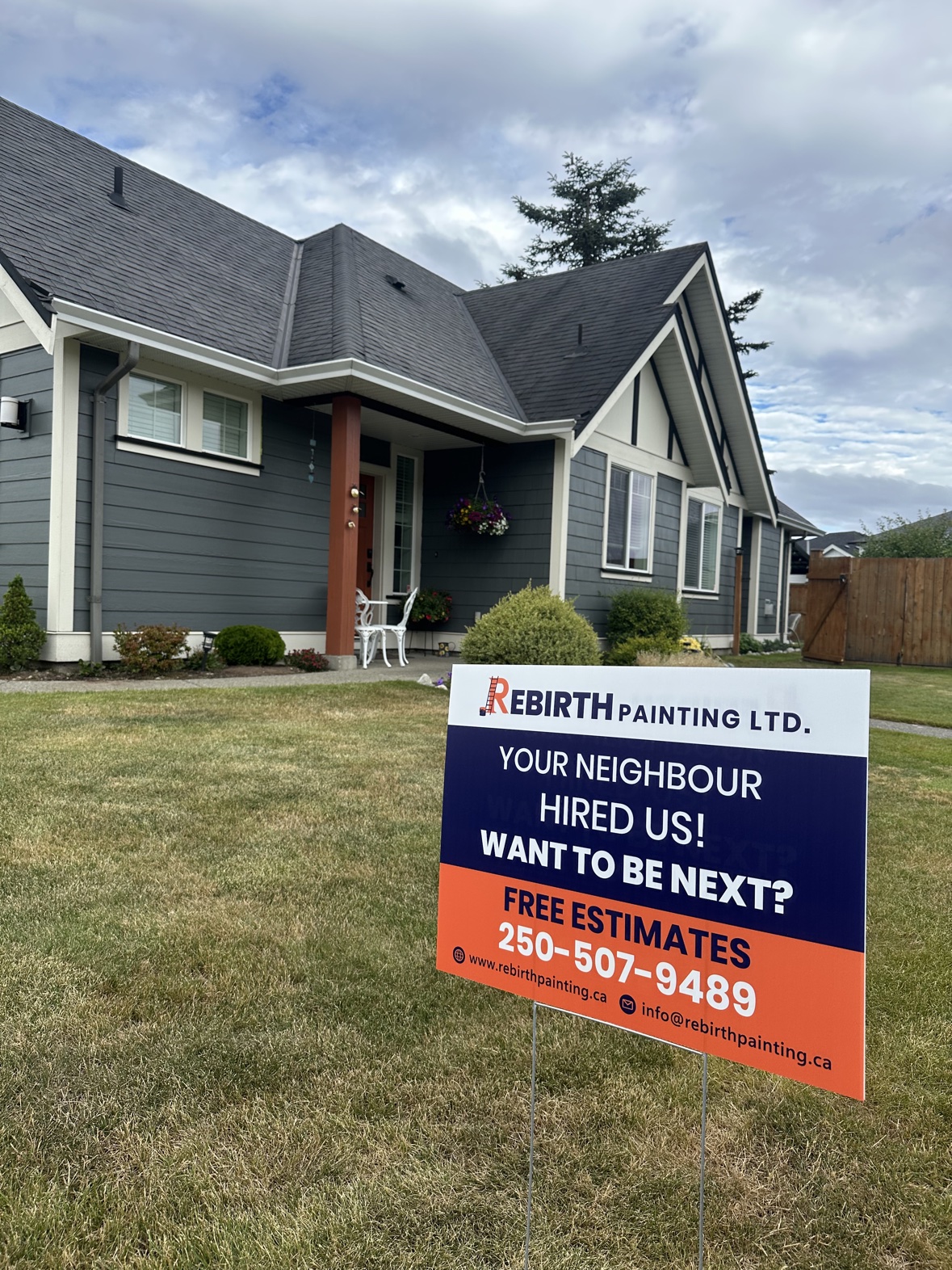 House exterior painting with a Rebirth Painting sign in Victoria, BC