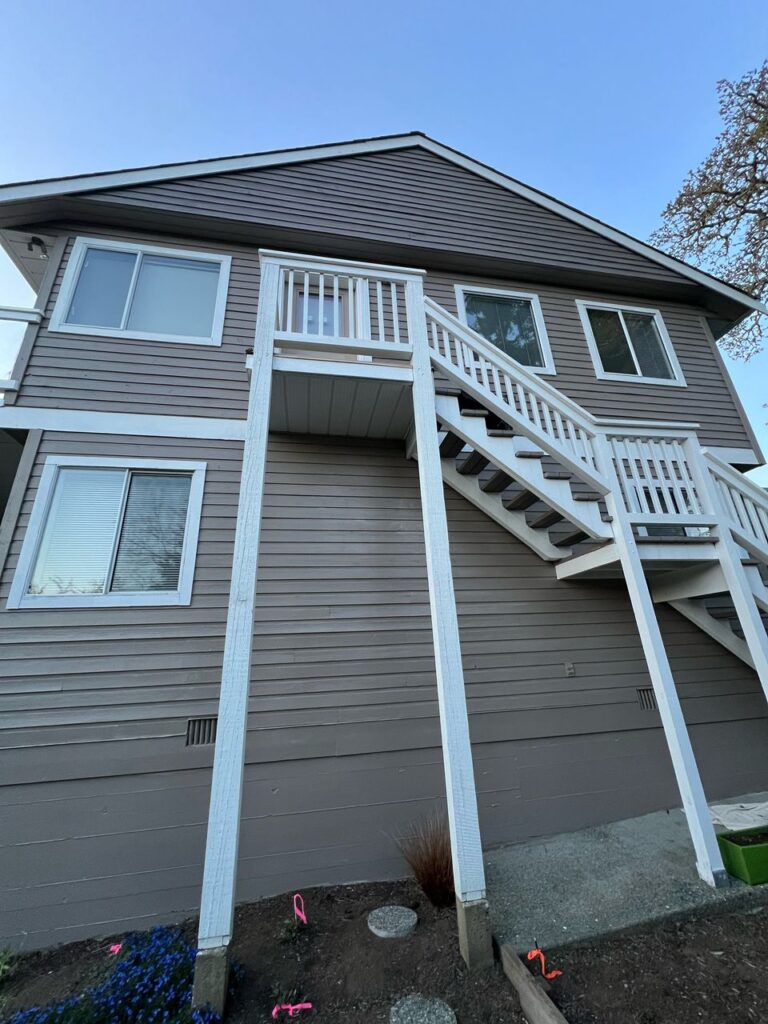 House exterior painting white staircase closeup victoria by Rebirth Painting Ltd. in Victoria, BC