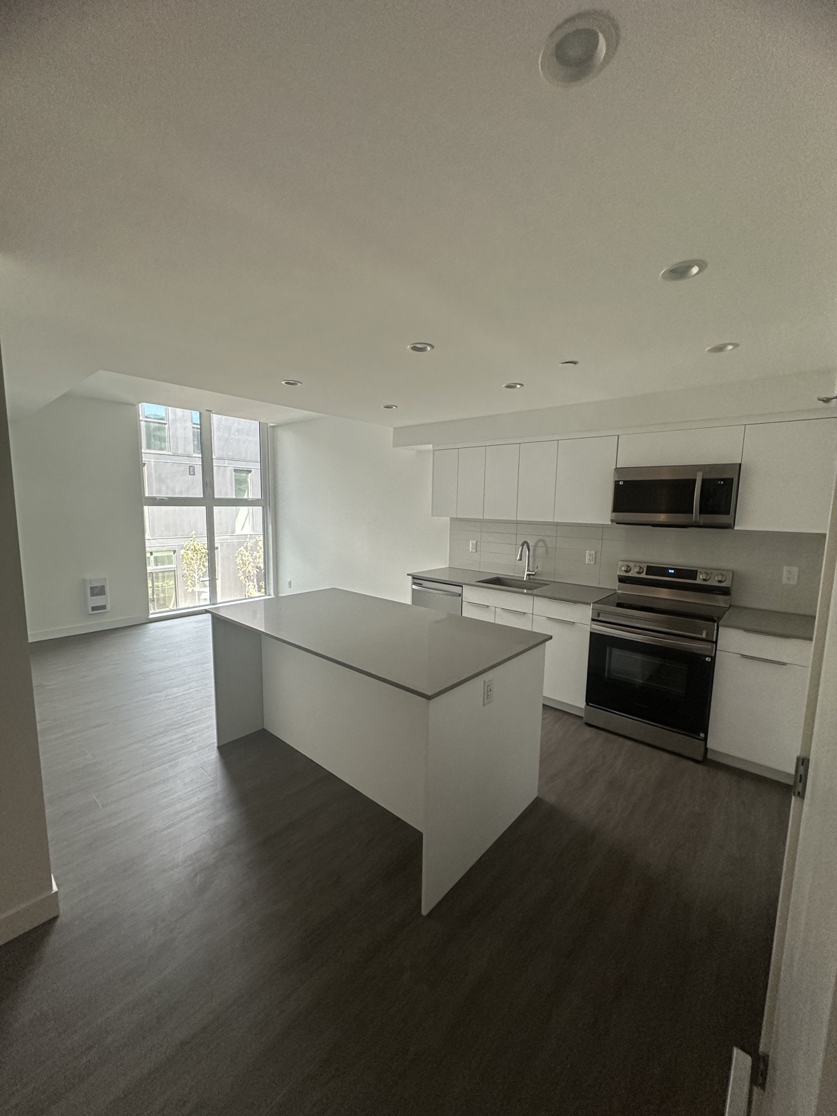 New construction painting of a modern white kitchen in Victoria, BC